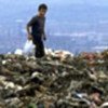 A boy scavenges through the refuse