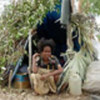 Woman in her shelter at Metinaro camp