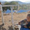 Child collects filtered water at a UNHCR-managed camp