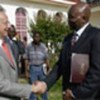 Dr. Conteh (R) welcomes Mr. da Costa on main campus