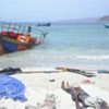 Bodies forced to jump off smuggler's boat lie on Yemeni shoreline
