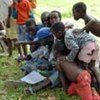 Children read about the UN's role at launch of an open dialogue program