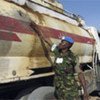 UNAMID peacekeeper examines fuel tanker hit by Sudanese army elements