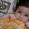 Turkmen child eating fortified bread