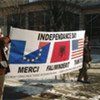 Ethnic Albanians display a banner during  celebration