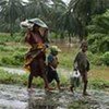 A Malagasy family walks in search of shelter from Cyclone Ivan