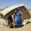 Sudanese family outside their tent in Kounoungou camp