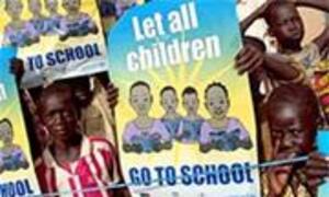 Children hold a UNICEF sign that reads 'Let all children GO TO SCHOOL' during an event.