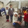 A woman poses with her small children in Kaliab Valley, Tajikistan