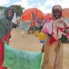 Displaced Somali women carrying away aid distributed in Afgooye