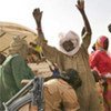 Chadian gendarmes search newly arrived refugees from Darfur at a camp in eastern Chad