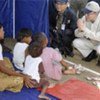 Secretary-General Ban Ki-moon (right) comforting children at a tent camp housing survivors of Cyclone Nargis