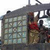 Refugees from Central African Republic stand at the back of a truck after arriving at Moula camp