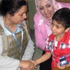 WHO Iraq representative Dr. Naeema Al-Gasseer talks with patients at a Baghdad hospital