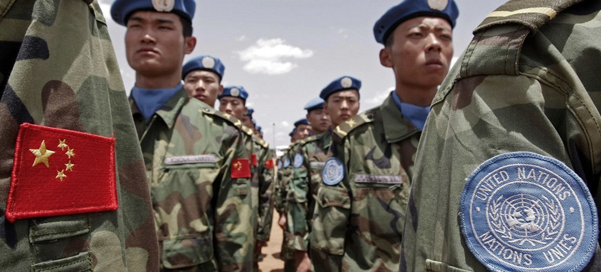 Chinese Engineers working for the UN-African Union Mission in Darfur (UNAMID) stand to attention upon arrival at their duty station in Nyala.