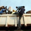 Sudanese refugee clambers onto a repatriation truck to join others returning home from Uganda