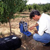 A scientist measures the soil humidity