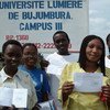 Students show their enrolment documents for Bujumbura’s Université Lumière