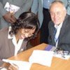 Executive Director of the Prisoners' Care Programme Jemima Gichungu and UN-HABITAT’s Bert Diphoorn sign agreement