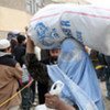 An Afghan returnee receives UNHCR winter supplies in Kabul.