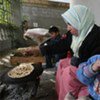 A Palestinian child eats home-made bread in the southern Gaza town of Rafah. Very few bakeries in the Strip still have flour to make bread.