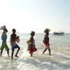 People wading out to a smuggler's boat on the coast of Somalia ahead of the Gulf of Aden crossing