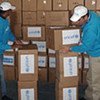 In a UNICEF warehouse in Zarka, Jordan, workers review boxes of supplies for shipment to the Gaza Strip