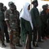 Ex-combatants from North and South Sudan, including women, symbolically handing over weapons