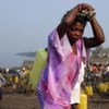 Women carry jerry cans of water in North Kivu