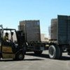 trucks being unloaded at the Kerem Shalom Crossing