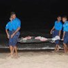 Injured civilian fleeing combat zone in the Vanni pocket is carried ashore by Sri Lankan Navy personnel