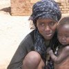 Displaced civilians, like this mother and her child in al-Junaynah in West Darfur, will be without aid if relief groups leave