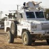 Armoured personnel carriers from UNAMID guard a supply convoy