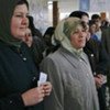 Iraqi women standing in line, ready to enter a polling station (file photo)