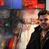Iraqi artist Wadhah Mahdi next to one of his colourful creations.