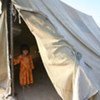 A young Afghan stands in the entrance of a UNHCR-supplied tent. Facebook users can help buy such tents for refugees