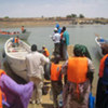 A boat with Mauritanian returnees approaches a landing point on the banks of the Senegal River