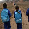 Schoolchildren on way to  temporary classrooms in earthquake-affected Gansu province, China