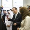 Secretary-General Ban Ki-moon (centre) holds a cultural artifact during a visit at a micro credit programme in Bahrain