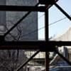 United Nations Headquarters building through the steel frame of the swing space for the General Assembly