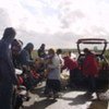 Local aid workers distribute food to some of the foreigners who have been living in makeshift shelters in the Calais area