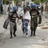 MINUSTAH police detain a presumed stone-throwing university student protester in Port-au-Prince, Haiti on 12 June 2009