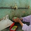 A girl washes her hands at a row of taps in Egypt