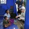 Secretary-General Ban Ki-moon (right) comforts survivors of cyclone Nargis in Bebaye Township, Myanmar on 22 May 2008