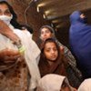 Internally displaced Pakistani women and girls queue for UNHCR relief items