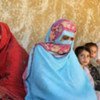 Displaced women and children rest in the dwelling of a host family in north-west Pakistan