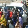 A crowd of Somalis pressing around a minibus, hoping to get out of Mogadishu [File Photo]