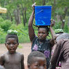 Refugees who fled rebel LRA attacks fetch water at the Makpandu refugee camp in southern Sudan