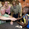 UN Special Envoy Bill Clinton greets a child at hospital in Gonaives while on visit to Haiti in July 2009