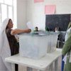 A woman casts her vote in the presidential and provincial council elections in Balkh province